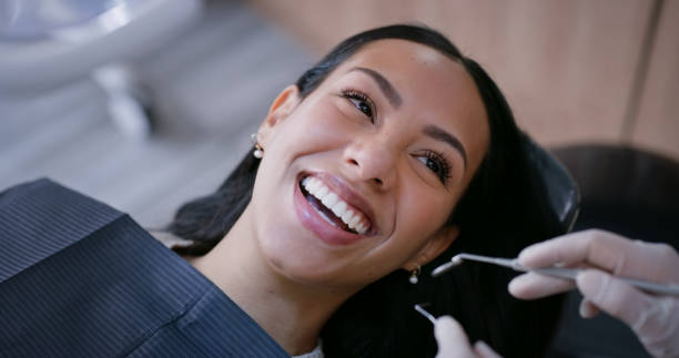a woman smiling brightly before a dental cleaning